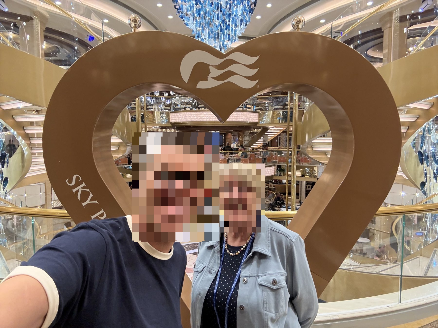 Mum framed by a heart sculpture in the Sky Princess atrium
