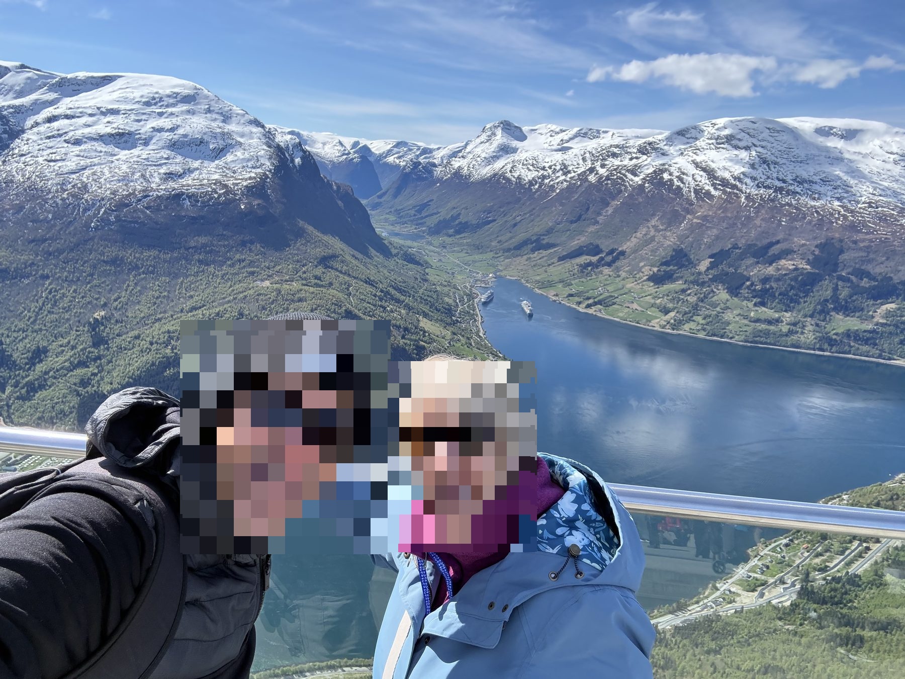 Summit selfie with snow peaks behind