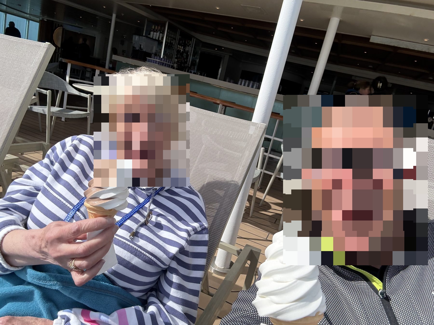 a mother and son on deck with ice creams in the sun