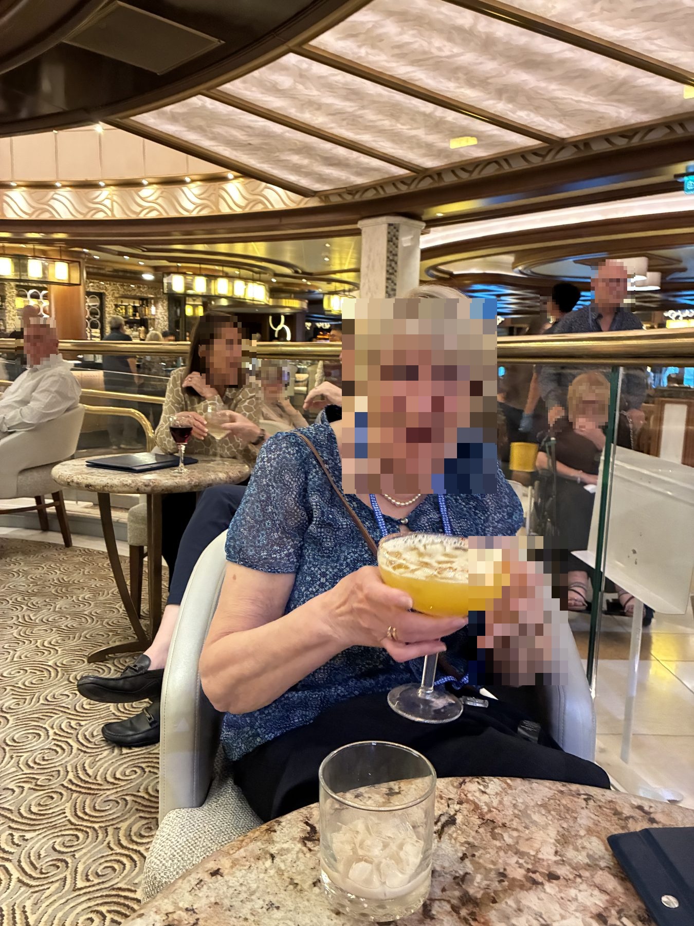 Mum laughing as she holds an enormous goblet cocktail