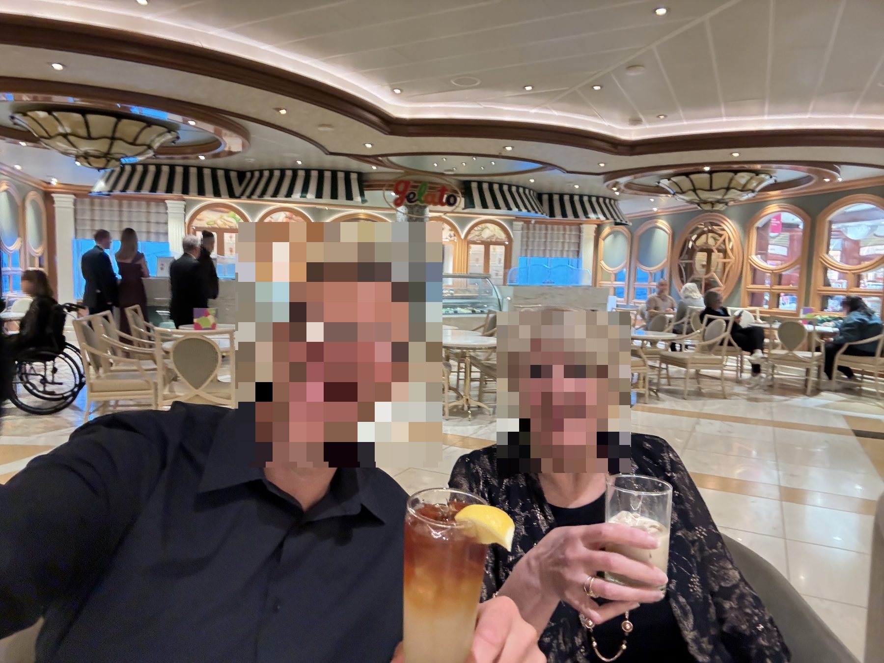 a mother and son together in the Piazza near the Gelato counter, drinks in hand