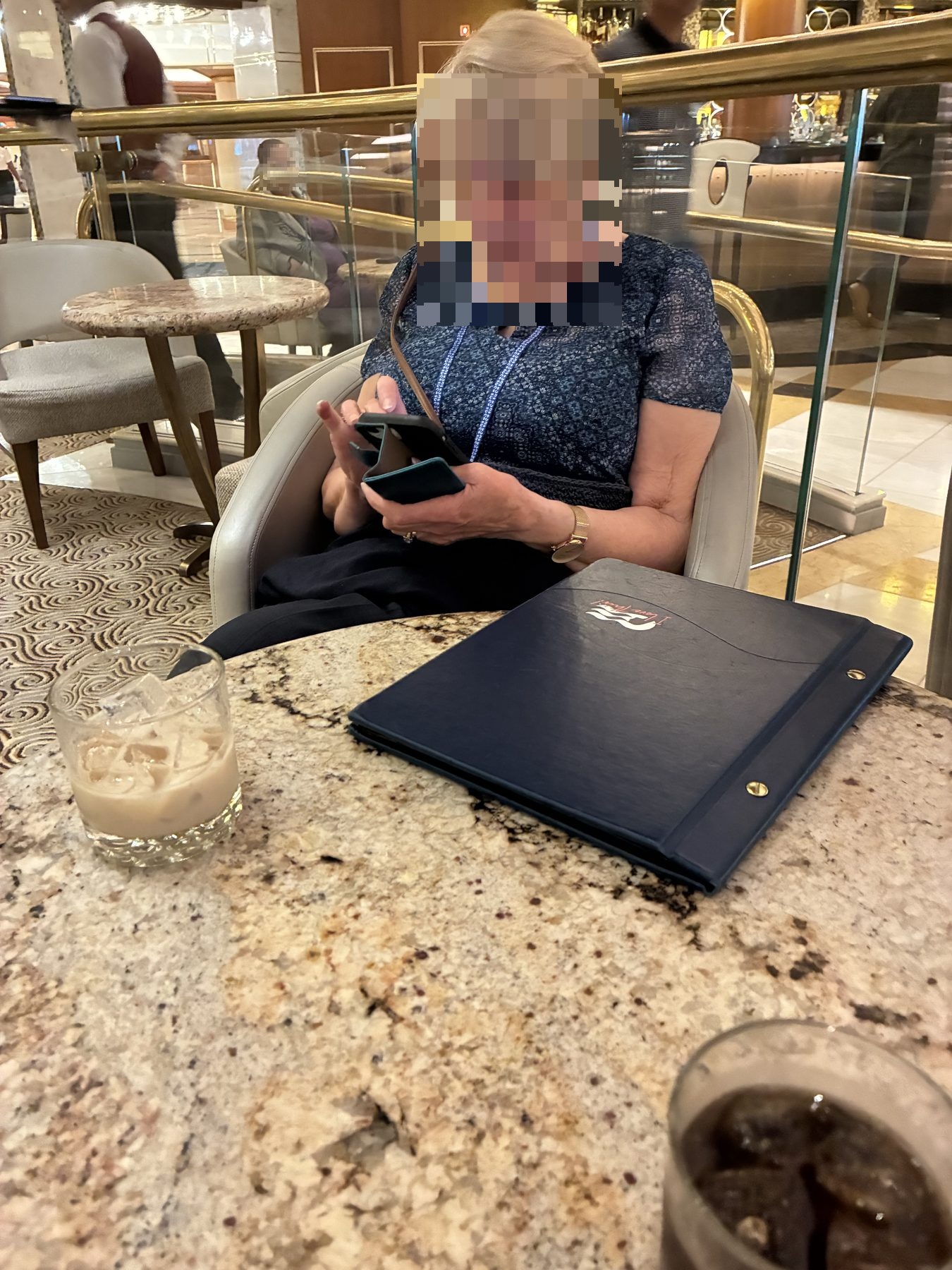 Mum reading the menu with a White Russian on the table