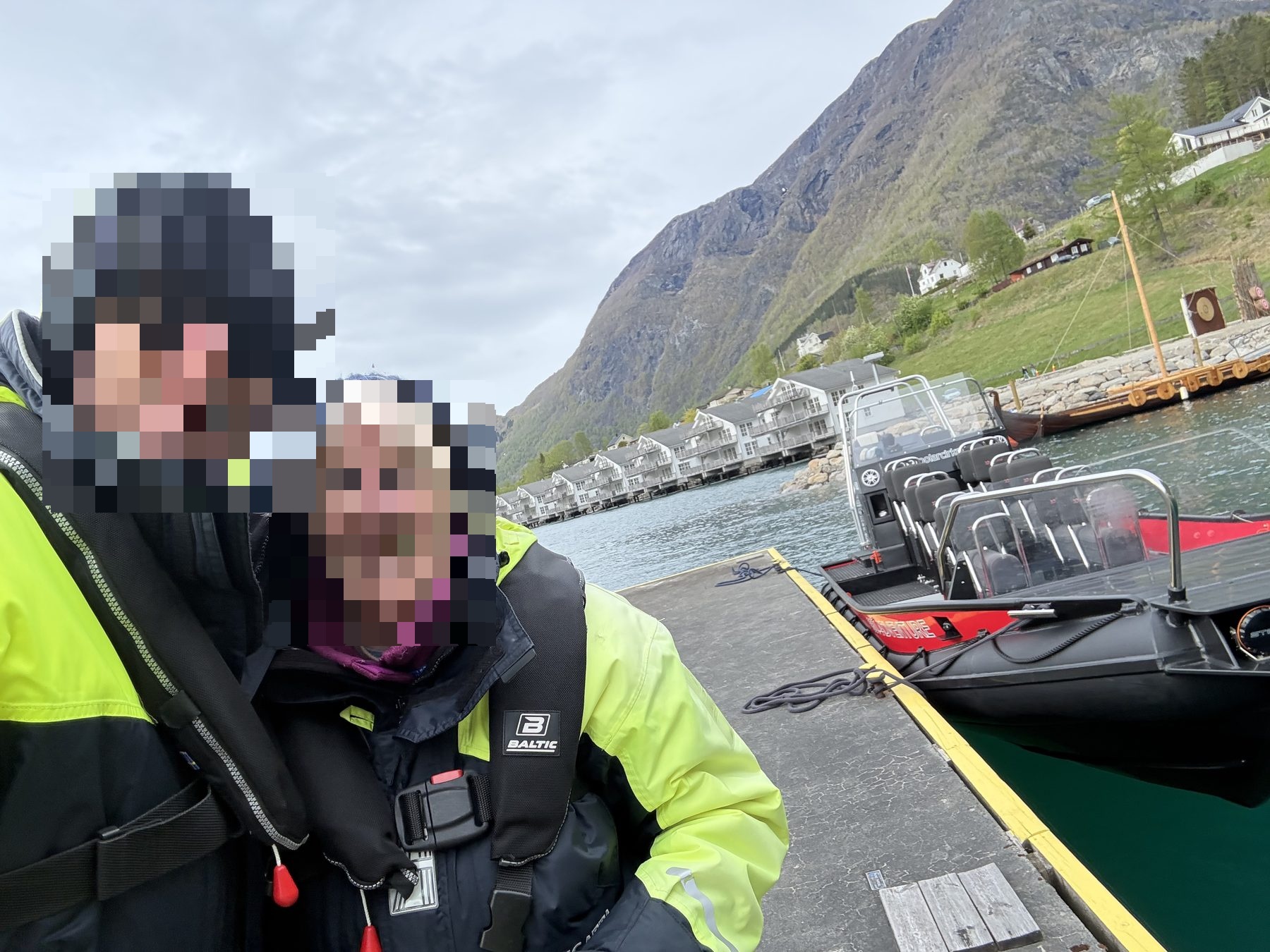 Selfie of a mother and son at the dock with RIB boats moored behind